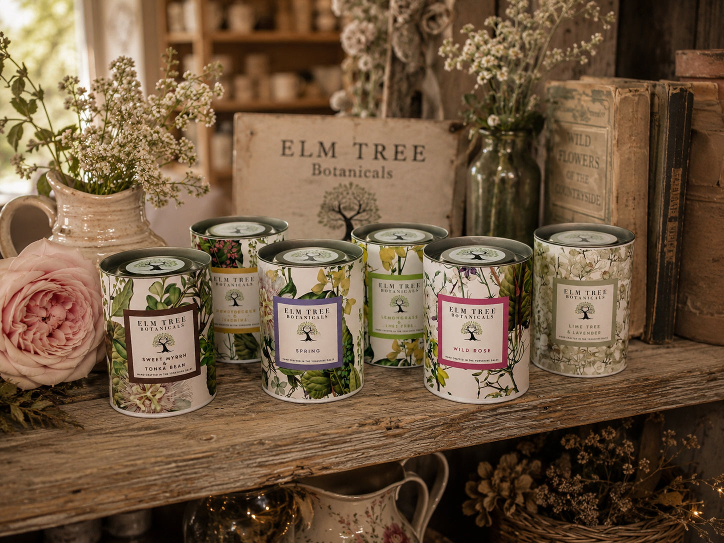 A collection of candles presented in branded packaging.